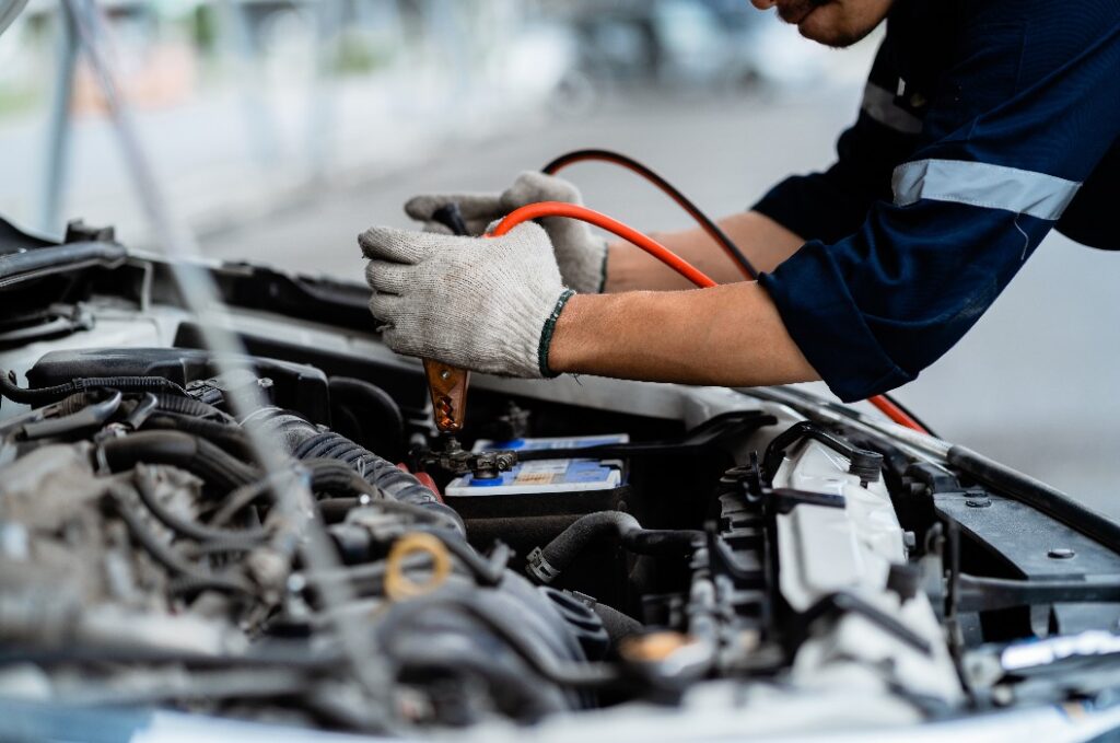 Close-up of automotive service technicians, repairs, maintenance and people concepts. Auto mechanic in the garage. Repair service concept.